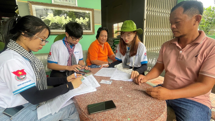 Đội hình trí thức khoa học trẻ tình nguyện TP.HCM đến nhà dân hướng dẫn bà con sử dụng các ứng dụng, cái đặt định danh điện tử - Ảnh: ĐẶNG TUYẾT